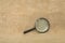 Old black magnifier on drapery background