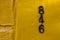 old black numbers in a yellow wall