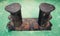 Old black rusted bollard on green ship deck