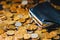 An old black wallet sits on top of a pile of Russian coins. The concept of inflation and poverty