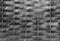 Old black and white metal wall background. Horisontal and vertical lines gate. City or rural rtexture. Dark geometric wallpaper