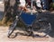 Old blue bicycle leaning against pole with blank blue sign