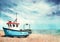 Old blue boat on a sandy beach