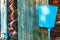 Old blue countryside washbasin hanging on wall of aged loghouse