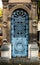 Old blue iron entrance door of a tomb / crypt at a cemetery