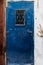 Old blue metal dirt door with keyhole and rusty metal lockas a beautiful vintage background