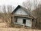 Old blue old dilapidated wooden abandoned ruined blue village house of beams with broken windows