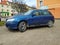 Old blue rusty Nissan Almera hatchback car parked