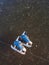 Old blue skates lie on the ice of a frozen lake in the early sunny morning in winter