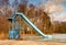 Old blue sliding track on lake beach, frozen watel level. Winter time