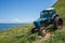 Old blue tractor on the sea coast