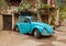 Old blue Volkswagen Beetle on exhibition in the Gardens Almona collection, in the rays of the setting sun, in the Druze village of