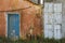 Old blue and white wooden doors of an abandoned orange house