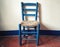 Old blue wooden chair with wicker seat