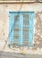 Old blue wooden window with rust - Hydra island Greece