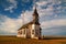 An old boarded up church and a new radio tower