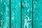 Old boards with cracked cyan paint. Textured wooden old background with vertical lines. Wooden planks close up for your