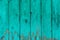 Old boards with cracked cyan paint. Textured wooden old background with vertical lines. Wooden planks close up for your