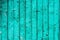 Old boards with cracked cyan paint. Textured wooden old background with vertical lines. Wooden planks for your design