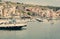 Old boat in Acitrezza harbor with fisher boats next to Cyclops islands, Catania, Sicily, Italy