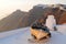 Old boat on greek island white rooftop with mountain and village panoramic view at sunset