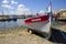 Old boat moored in Saint-Tropez, France, with the text St. Tropez written in it