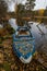 Old boat in october with lots of leafs