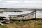 An old boat on the sand on the side of an estuary