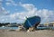 Old boat on the shore with Marsaxlokk village Malta background, traditional old maltese boat on the coast, boat ruins