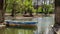 Old boat sitting on a small lake in a park