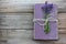 Old book decorated with lavender flowers and tied with jute twine on wooden table.