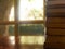 Old book stacking on wooden table in front of window at library room.