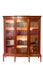 An old bookcase with books and glass doors isolated on white background