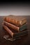 Old books piled on a antique wooden table