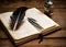 old books, scrolls, ink pen and inkwell on wooden table on brown background