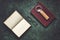 Old books, spectacles, and a magnifying glass with a leather handle, dark and moody, top view