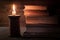 old books on a wooden table by candlelight