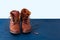 Old boot red brown shoes blue top view background red leather laces high canvas dirty