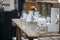 old bottles and pharmacy jars on a wooden chest of drawers for sale