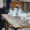 Old bottles and pharmacy jars on a wooden chest of drawers for sale