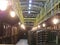 Old bottles of wine in rows in wine cellar. Rows of many wine bottles in winery cellar storage. Beautiful texture or