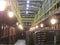 Old bottles of wine in rows in wine cellar. Rows of many wine bottles in winery cellar storage. Beautiful texture or