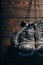 Old boxing gloves hanging on nail on wooden wall.