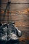 Old boxing gloves hanging on nail on wooden wall.