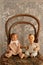 Old boy and girl dolls on an old chair with a lace