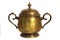 An old brass or bronze metal sugar bowl with a lid and ornament. Metal punctles with scratches and patina.