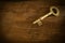 Old brass keys placed on a wooden floor low key light.
