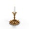 Old brass plated candlestick with candle isolated on white. 3D illustration