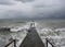 An old breakwater and a seagull on the Black Sea in winter in stormy weather