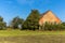 Old brick barn in the Czech countryside. Agricultural landscape. Hot summer day on the farm